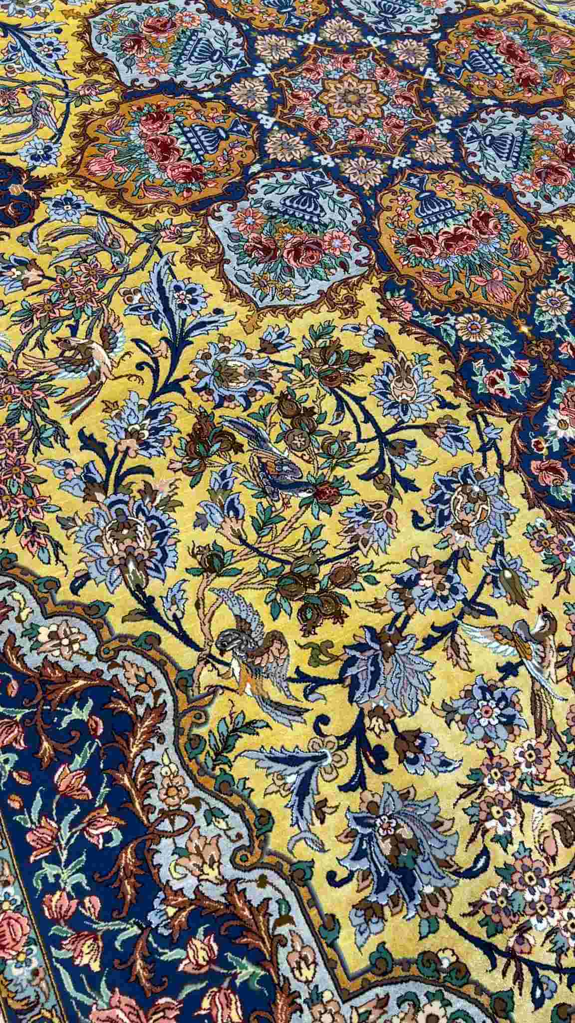 "Elegant Isfahan Oriental rug with detailed floral patterns and silk accents, 10.2 x 6.9 feet."